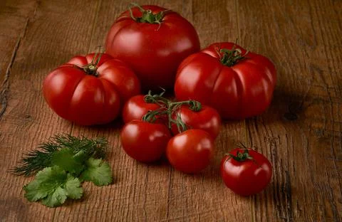 Tomatoes on rustic wooden background Stock Photos