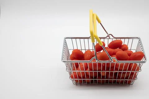 Tomatoes in a small basket for purchase Stock Photos