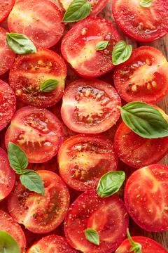 Tomatoes with spices and basil. Stock Photos