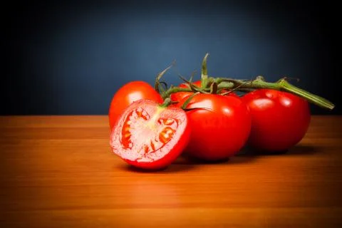 Tomatoes On Table In Front Of Black Background Stock-Fotos