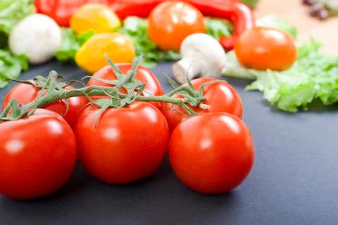Tomatoes on the table. Red tomatoes lie on the old table. Dietary food. Tomat Stock Photos