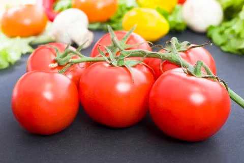 Tomatoes on the table. Red tomatoes lie on the old table. Dietary food. Tomat Stock Photos
