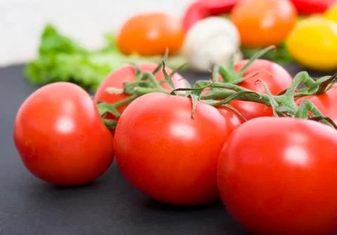 Tomatoes on the table. Red tomatoes lie on the old table. Dietary food. Tomat Stock Photos