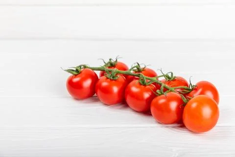 Tomatoes on  texture background. Cherry tomatoes on the kitchen table Stock Photos
