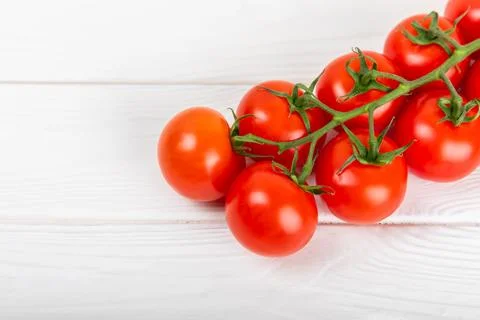 Tomatoes on  texture background. Cherry tomatoes on the kitchen table Stock Photos