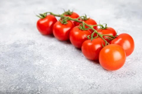 Tomatoes on  texture background. Cherry tomatoes on the kitchen table Stock Photos