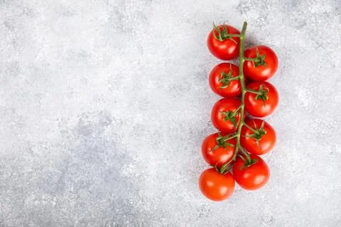 Tomatoes on  texture background. Cherry tomatoes on the kitchen table Stock Photos