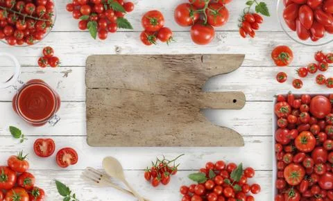 Tomatoes top view on kitchen white wooden table with cutting board copy space Stock-Fotos