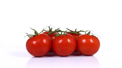 Tomatoes turning on white background Stock Footage 171634932