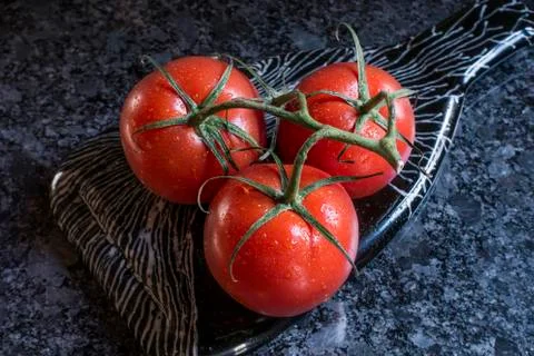 Tomatoes with vine Stock Photos