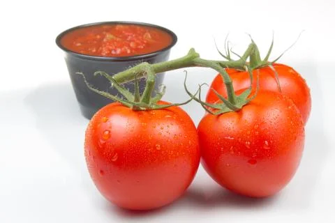 Tomatoes on the Vine with Salsa Stock Photos