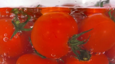 Tomatoes in water with air bubbles. Stock Footage 83008493