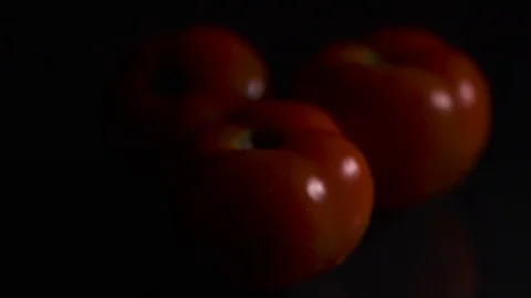 Tomatoes with water drops on a black background Stock Footage 94913596