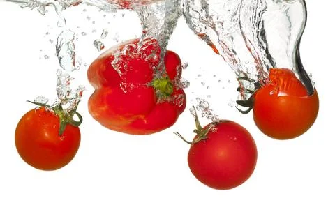 Tomatoes in water splash Stock Photos