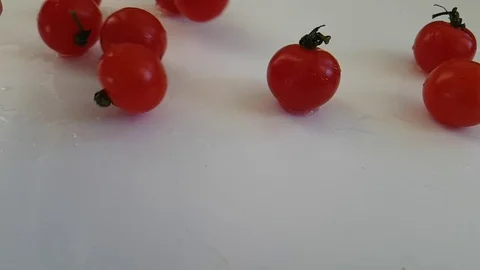 Tomatoes wet on a white background spinning Stock Footage 87655713