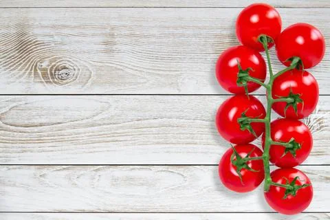 Tomatoes on white plank Stock Photos