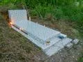 Tombstones on grassy jungle mountain hill in poor Indonesian village Photo