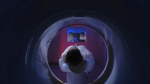Tomograph. The patient on the CT scan. View through the tomograph from behind. Stock Footage 120651790