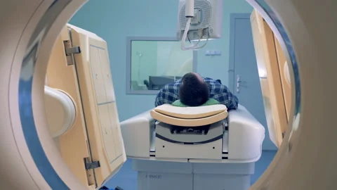 Tomographic scanning platforms. MRI scanner, tomograph with patient getting Stock-Footage 90898708