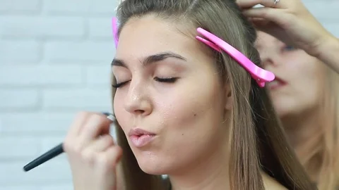 Tonal foundation makeup applied on the face of a supermodel Stock Footage 81573976