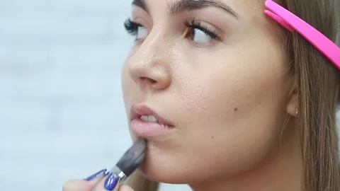 Tonal foundation makeup applied on the face of a supermodel Stock Footage 81574011
