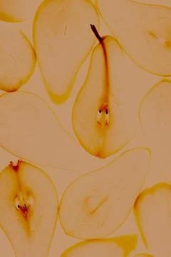 Toned image of close up texture of backlit illuminated pear slices. Autumn food Stock Photos