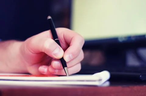 Toned man hand write pen paper Stock Photos