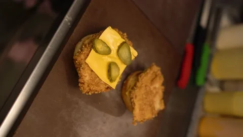 Tongs Place Second Beef Patty On Cheeseburger In Fast Food Kitchen Stock Footage 196197749