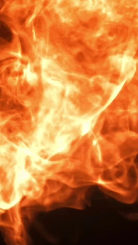 Tongues of bright fire on a black background. Filmed on a high-speed camera at Stock Footage 335383080