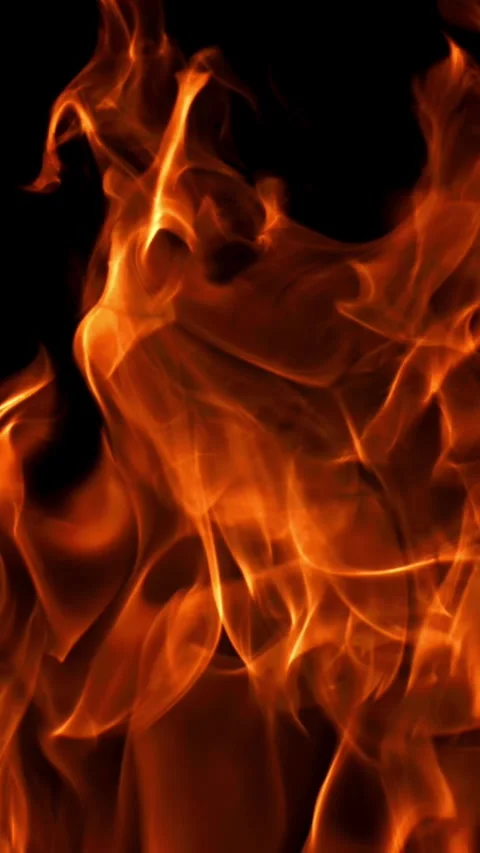 Tongues of bright fire on a black background. Filmed on a high-speed camera at Stock Footage 335383998