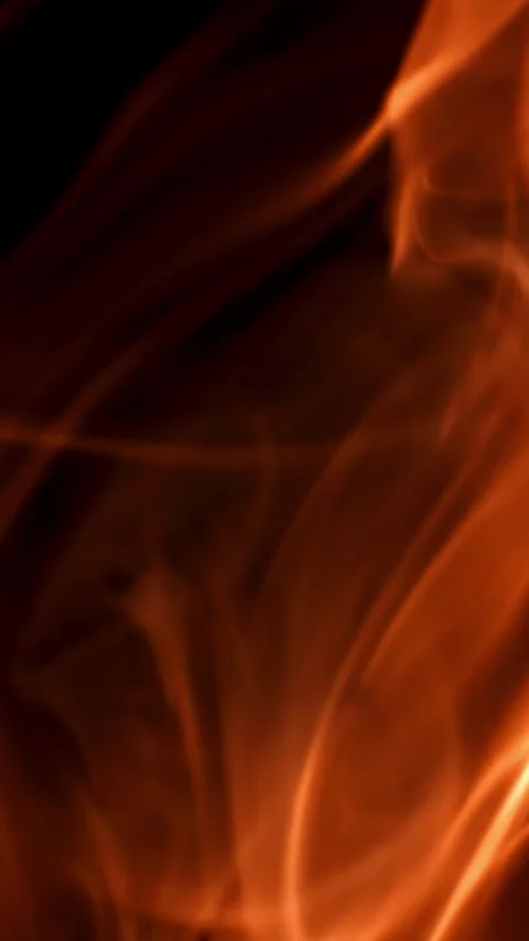 Tongues of bright fire on a black background. Filmed on a high-speed camera at Stock Footage 335384185
