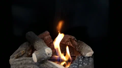 Tongues of flame go through slot in metal plate with stones in form of well on Stock Footage