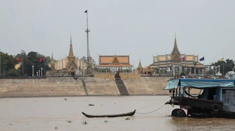 Tonle Sap river Phnom Penh palace float-by larger boat drags dingy Stock Footage 50363459