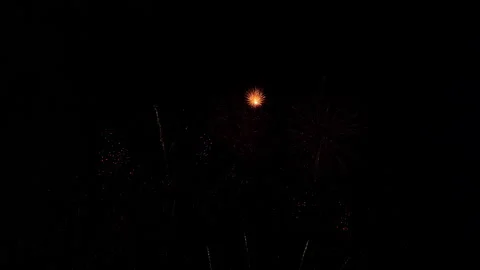 Tons of tiny fireworks explode in the dark sky. 스톡 동영상 227476041