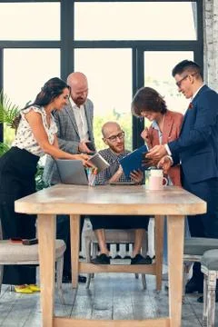 Too many work. Selective focus of young business man surrounded by colleagues 写真素材