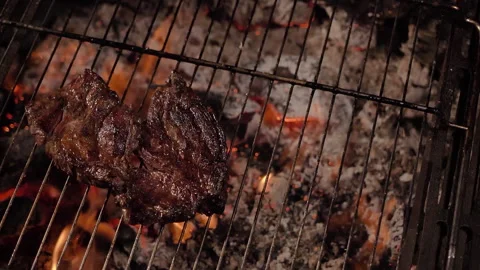 Too well done beef steak on a barbecue grill. Stock Footage 135612392