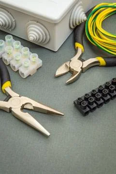 Tool and accessories used in electrical installation on gray workshop table Stock Photos