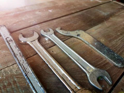 Tool Background on Wooden surface with Wrenches , selective focus on spanner Stock Photos