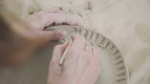 Tool for clay - stack. Hands ceramist: drawing pattern on a clay plate Stock Footage 73229913