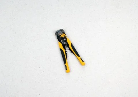 A tool for crimping stranded electrical wires. Crimping black and yellow tool 스톡 사진