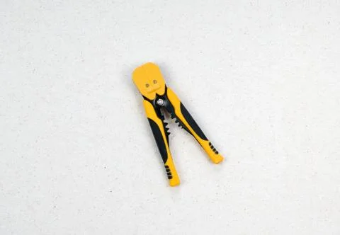 A tool for crimping stranded electrical wires. Crimping black and yellow tool Stock Photos
