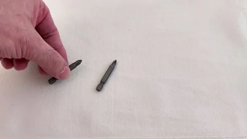 Tool Detail: Screwdriver Bits Arranged on White Fabric Base Stock Footage 321449976