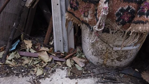 Tool for drilling in the ground. A piece of old carpet. Household garbage. 動画素材 116896597