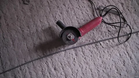 Tool grinder lies on the floor Stock Footage 176421701