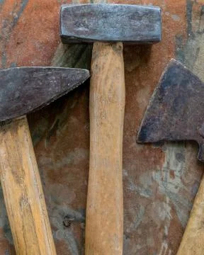 Tool kit of three elements an ax and a pair of hammers close-up Stock Photos