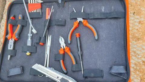 A tool kit with a variety of tools including pliers, scissors, and wrenches Stock Photos