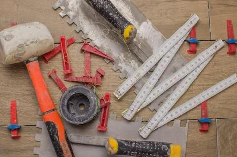 A tool for laying ceramic tiles in the form. Trowel, toothed spatula, fishing Stock Photos