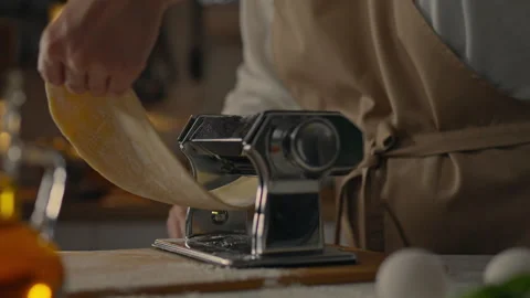 Tool, professional chef prepares Rolls out dough for cooking pasta in a take Stock Footage 248176856