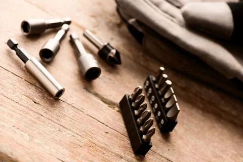 Tool set of screwdriver bits with different nozzles on wooden desk. Stock Photos