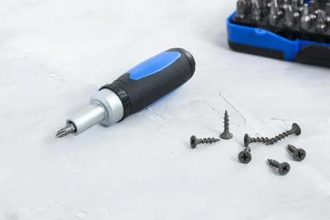 Tool set screwdriver with different nozzles and screws Stock Photos